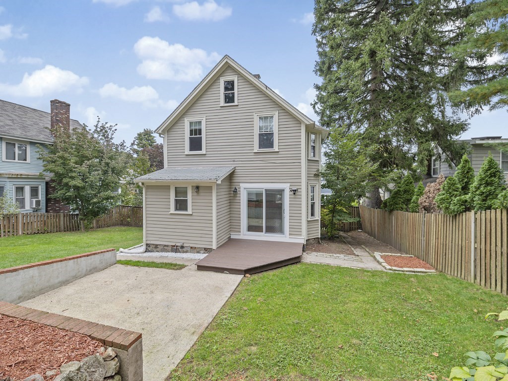 89 Green Street Wakefield, MA 01880 - Photo 30 of 38 a view of a house with a yard and wooden fence