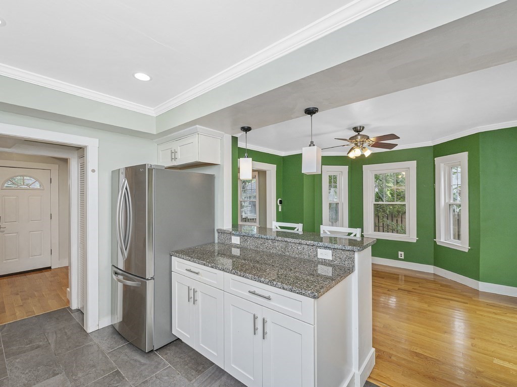 89 Green Street Wakefield, MA 01880 - Photo 5 of 38 a kitchen with granite countertop a refrigerator and a sink