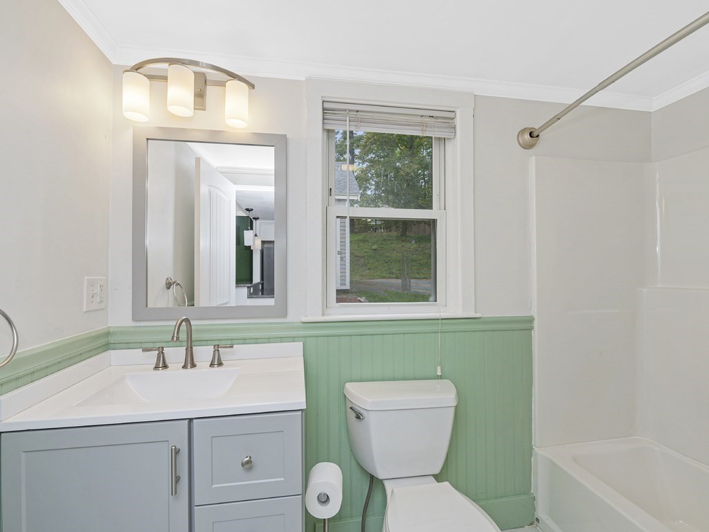 89 Green Street Wakefield, MA 01880 - Photo 10 of 38 a bathroom with a toilet sink and mirror