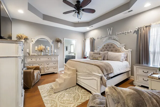 a bedroom with a bed and wooden floor