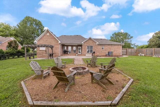 a view of a house with backyard sitting area and garden