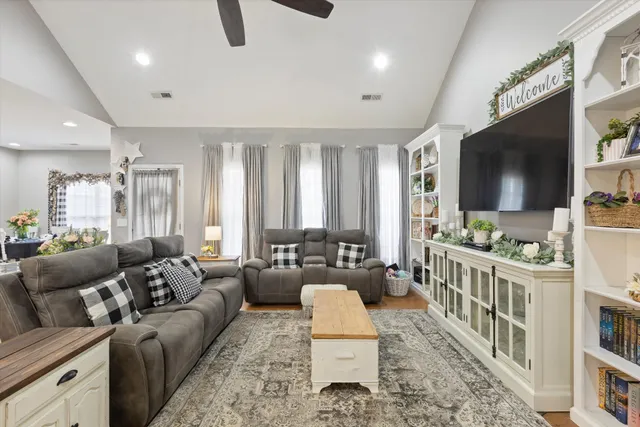 a living room with furniture and a flat screen tv