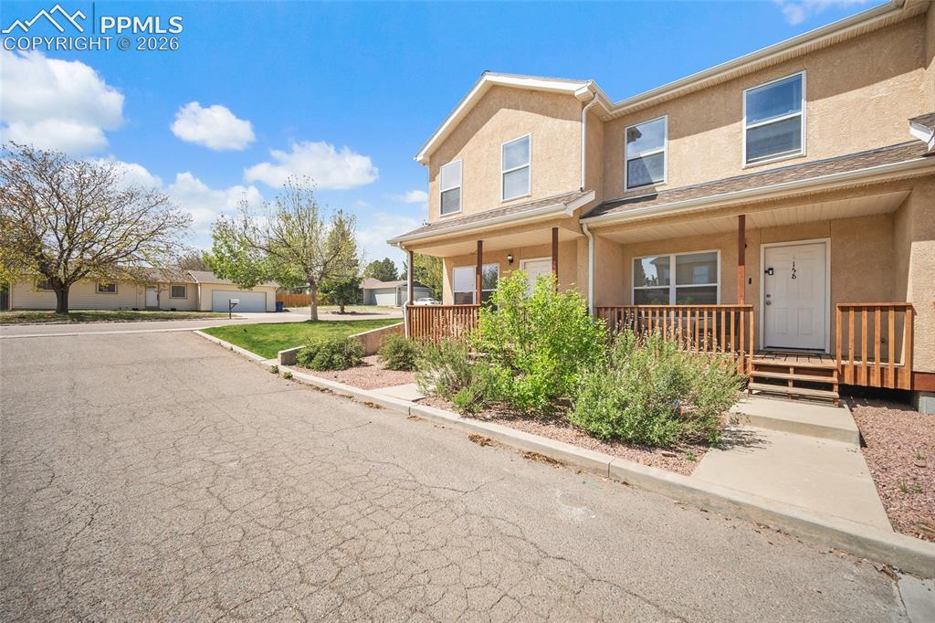 4400 Rawhide Road, Unit 157 Pueblo, CO 81008 - Photo 34 of 36 a view of a brick house with a yard