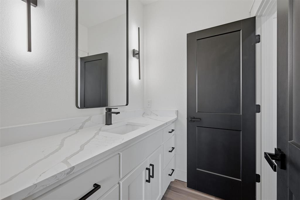 1805 Arthur Road Denison, TX 75021 - Photo 29 of 40 a bathroom with a double vanity sink and mirror