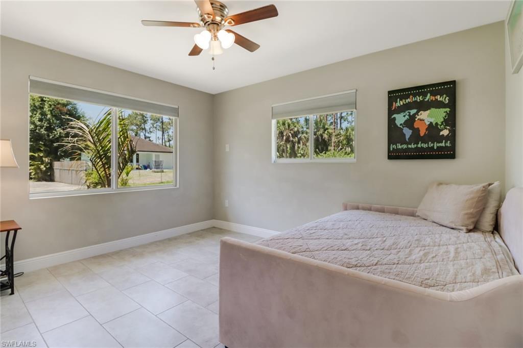 4355 Pine Ridge Road Naples, FL 34119 - Photo 12 of 23 a bedroom with a bed and a window