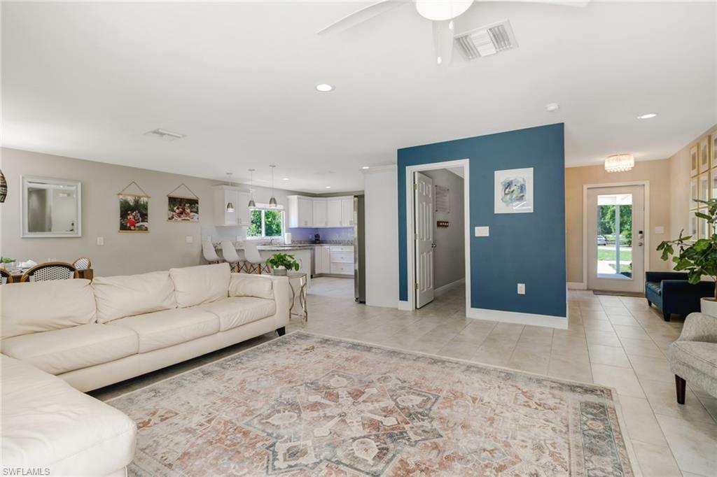4355 Pine Ridge Road Naples, FL 34119 - Photo 13 of 23 a living room with furniture and a refrigerator