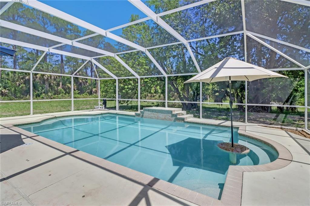 4355 Pine Ridge Road Naples, FL 34119 - Photo 15 of 23 a view of a backyard with swimming pool and couches