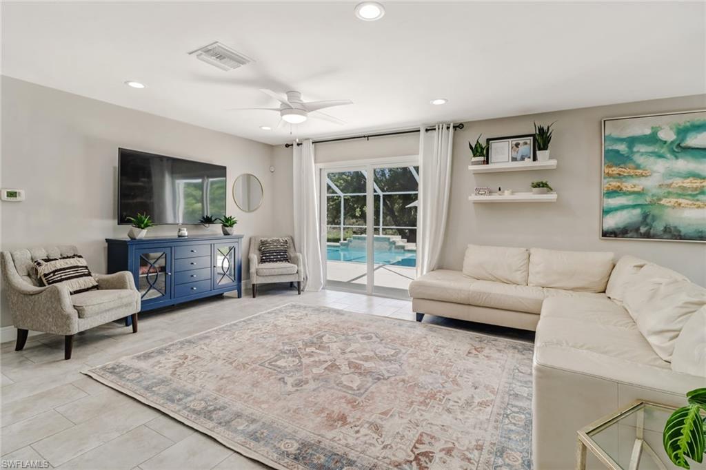 4355 Pine Ridge Road Naples, FL 34119 - Photo 16 of 23 a living room with furniture and a flat screen tv