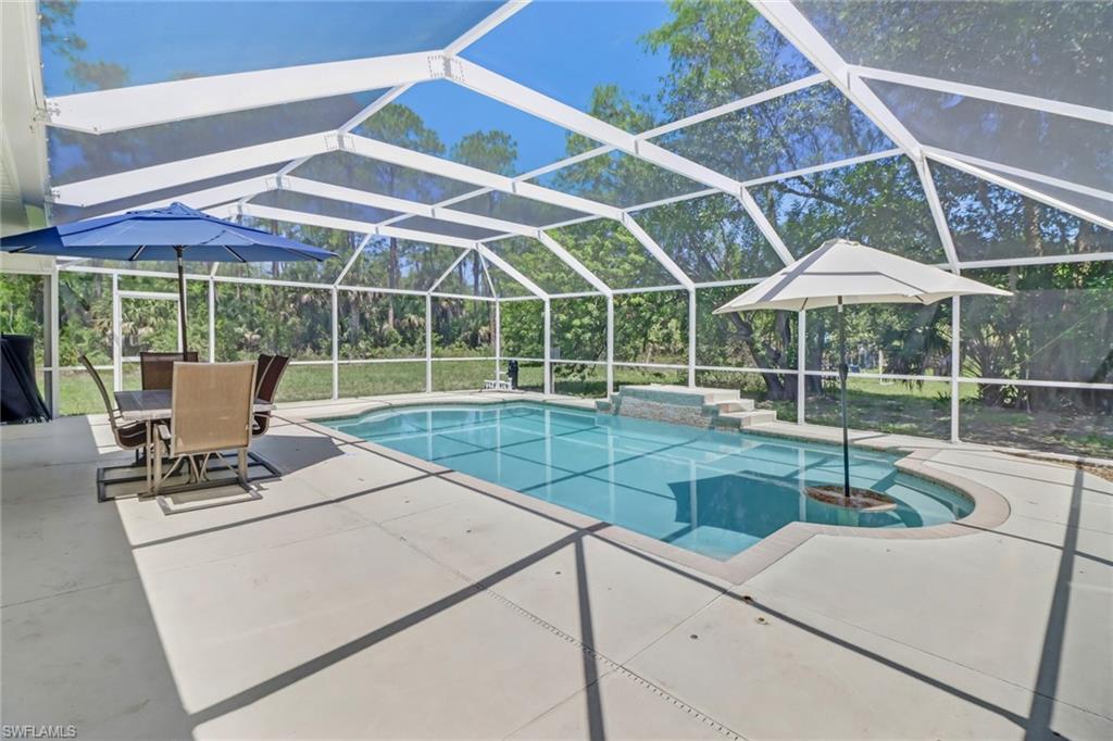 4355 Pine Ridge Road Naples, FL 34119 - Photo 4 of 23 a view of backyard with swimming pool and chairs