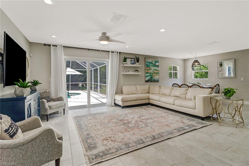 4355 Pine Ridge Road Naples, FL 34119 - Photo 5 of 23 a living room with furniture and a flat screen tv