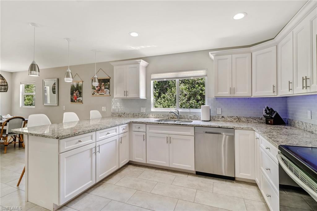 4355 Pine Ridge Road Naples, FL 34119 - Photo 6 of 23 a kitchen with a sink and cabinets