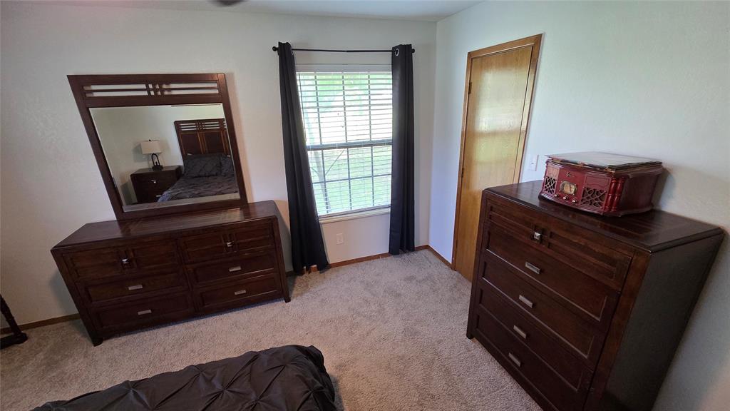 338 Travis Road Decatur, TX 76234 - Photo 14 of 40 a bedroom with a bed and wooden floor