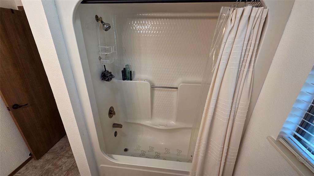 338 Travis Road Decatur, TX 76234 - Photo 19 of 40 a bathroom with a bathtub