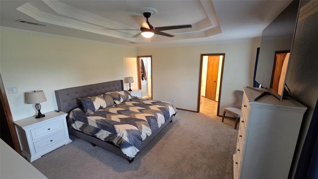 338 Travis Road Decatur, TX 76234 - Photo 21 of 40 a bedroom with a bed dresser and a window