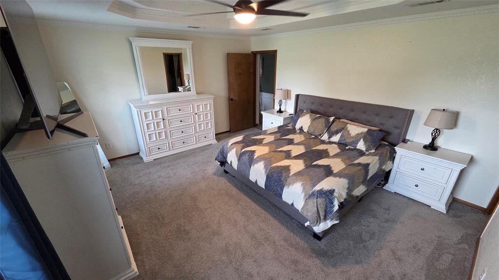 338 Travis Road Decatur, TX 76234 - Photo 22 of 40 a bed sitting in a room next to a window