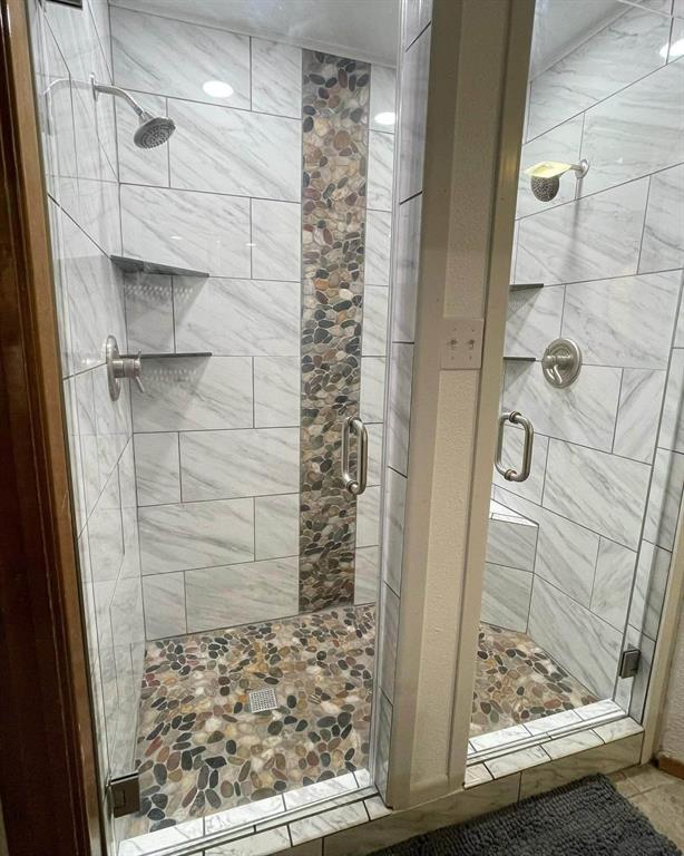 338 Travis Road Decatur, TX 76234 - Photo 25 of 40 a bathroom with a glass door shower and vanity
