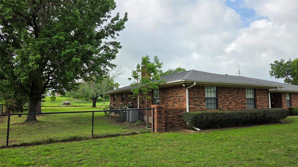 338 Travis Road Decatur, TX 76234 - Photo 3 of 40 a front view of a house with a garden