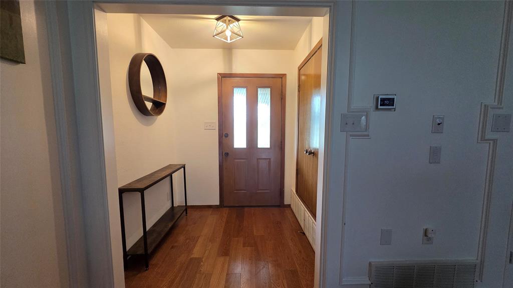 338 Travis Road Decatur, TX 76234 - Photo 6 of 40 a view of a hallway with wooden floor