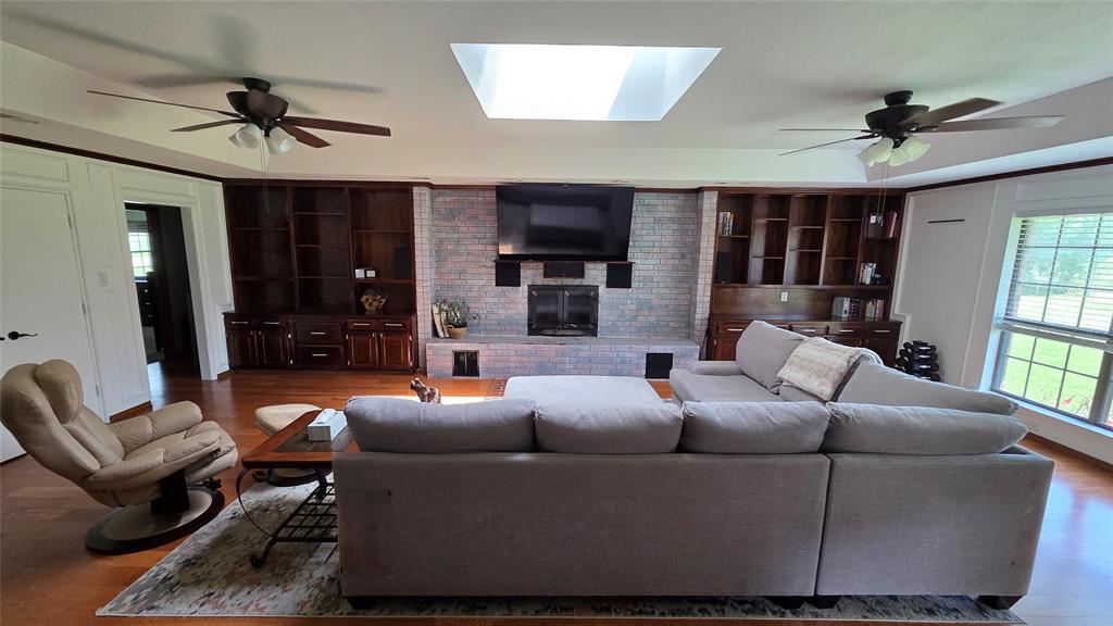 338 Travis Road Decatur, TX 76234 - Photo 8 of 40 a living room with furniture a ceiling fan and a window