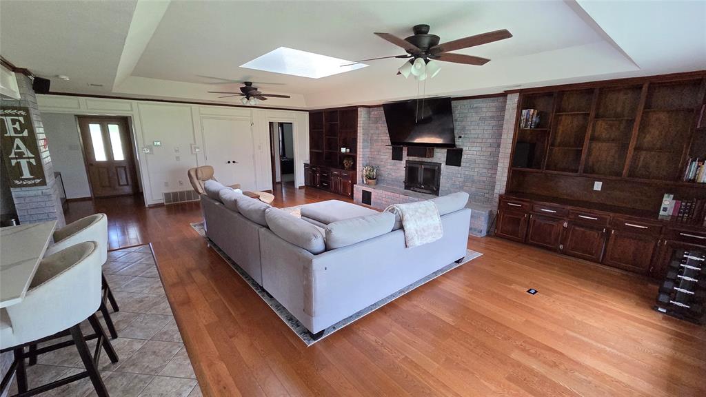 338 Travis Road Decatur, TX 76234 - Photo 9 of 40 a living room with furniture and wooden floor