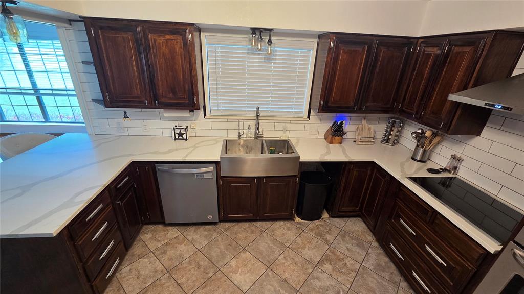 338 Travis Road Decatur, TX 76234 - Photo 10 of 40 a kitchen with a sink and wooden cabinets