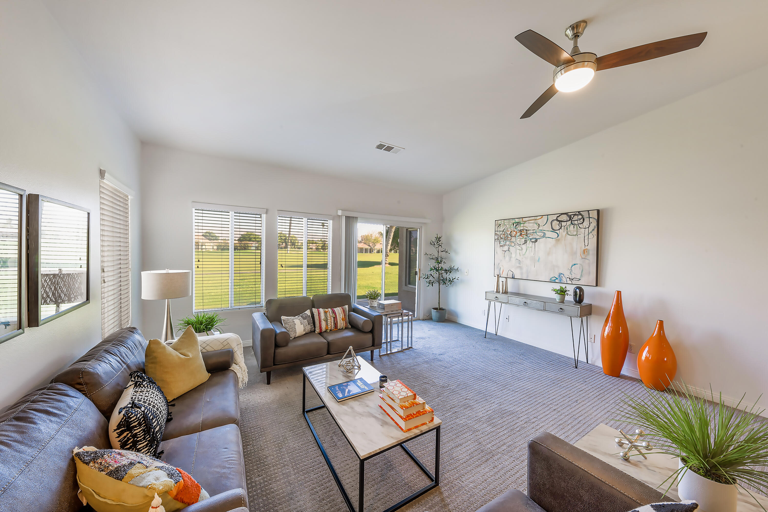 82346 Lancaster Way, Unit 125 Indio, CA 92201 - Photo 1 of 34 a living room with furniture and a large window