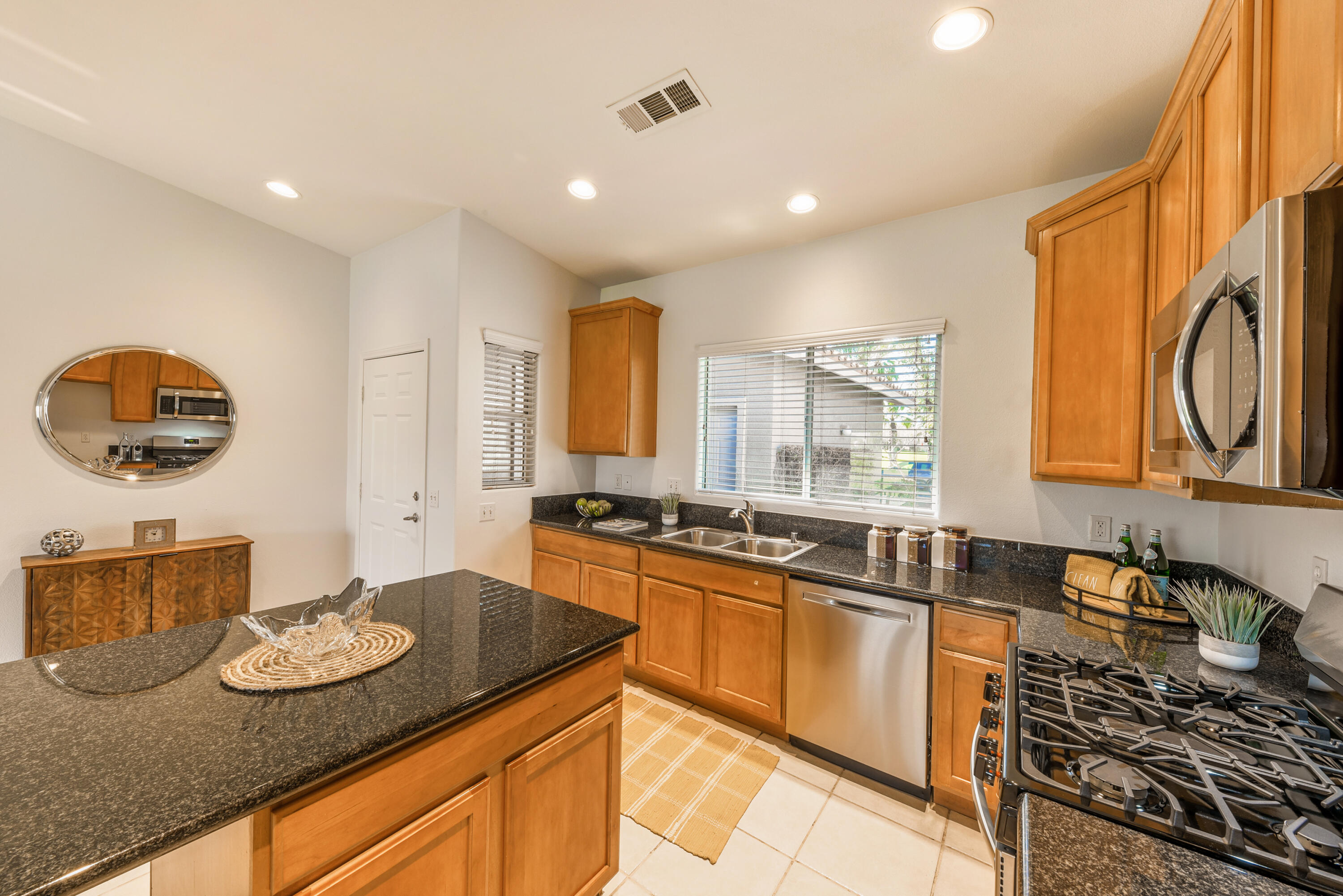82346 Lancaster Way, Unit 125 Indio, CA 92201 - Photo 12 of 34 a kitchen with stainless steel appliances granite countertop a stove and a sink