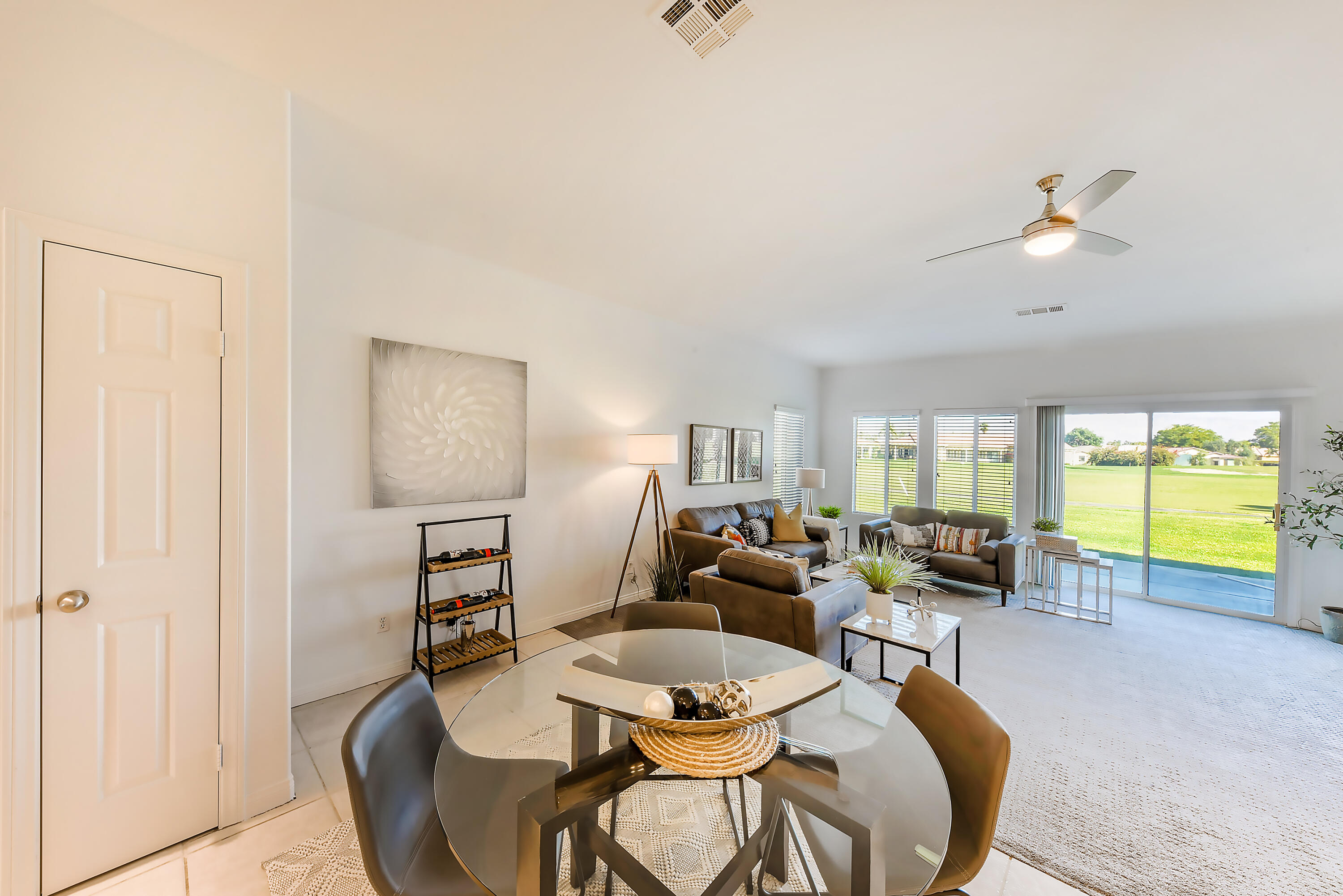 82346 Lancaster Way, Unit 125 Indio, CA 92201 - Photo 13 of 34 a living room with furniture a flat screen tv and a large window