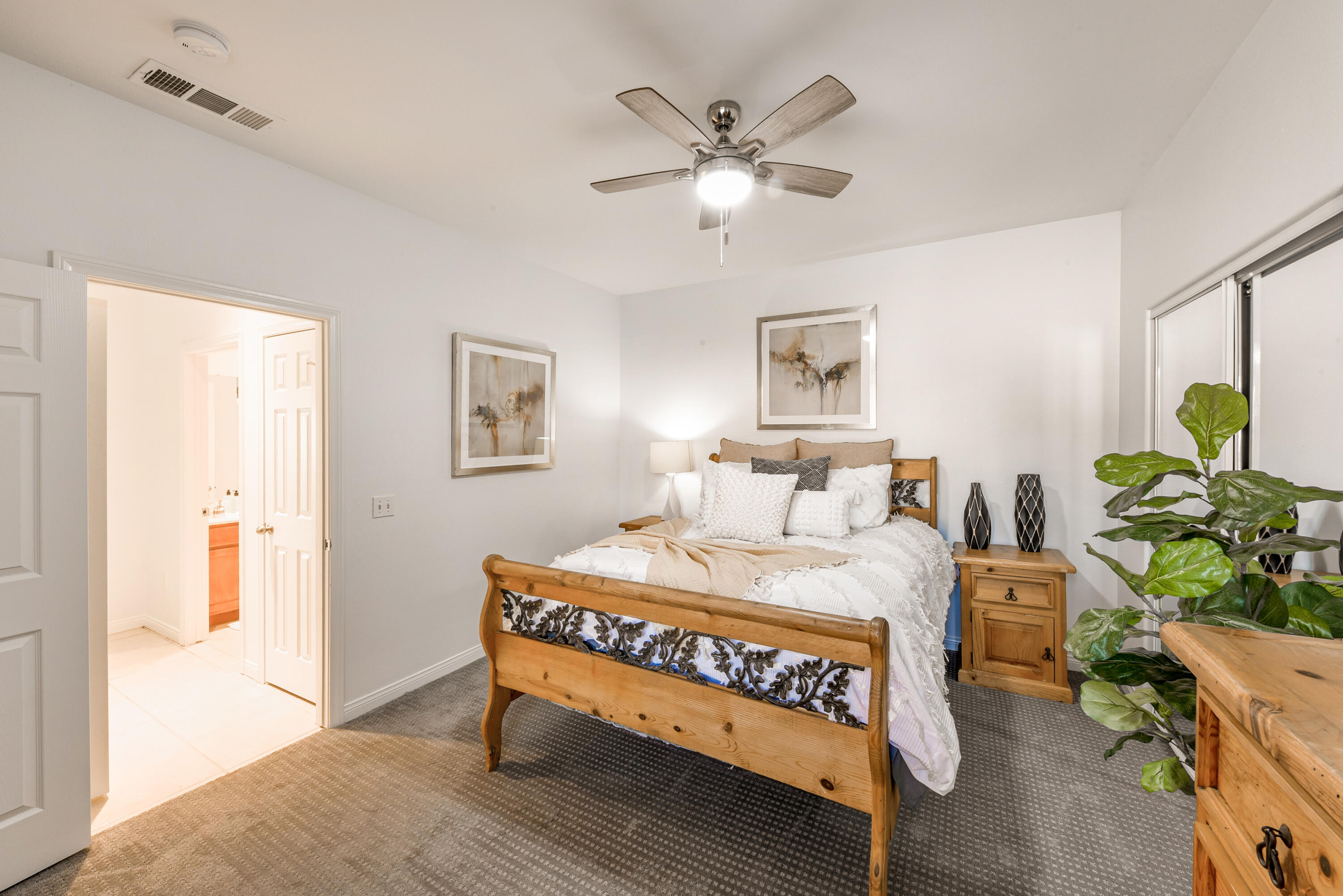 82346 Lancaster Way, Unit 125 Indio, CA 92201 - Photo 16 of 34 a bedroom with a bed chandelier and a window