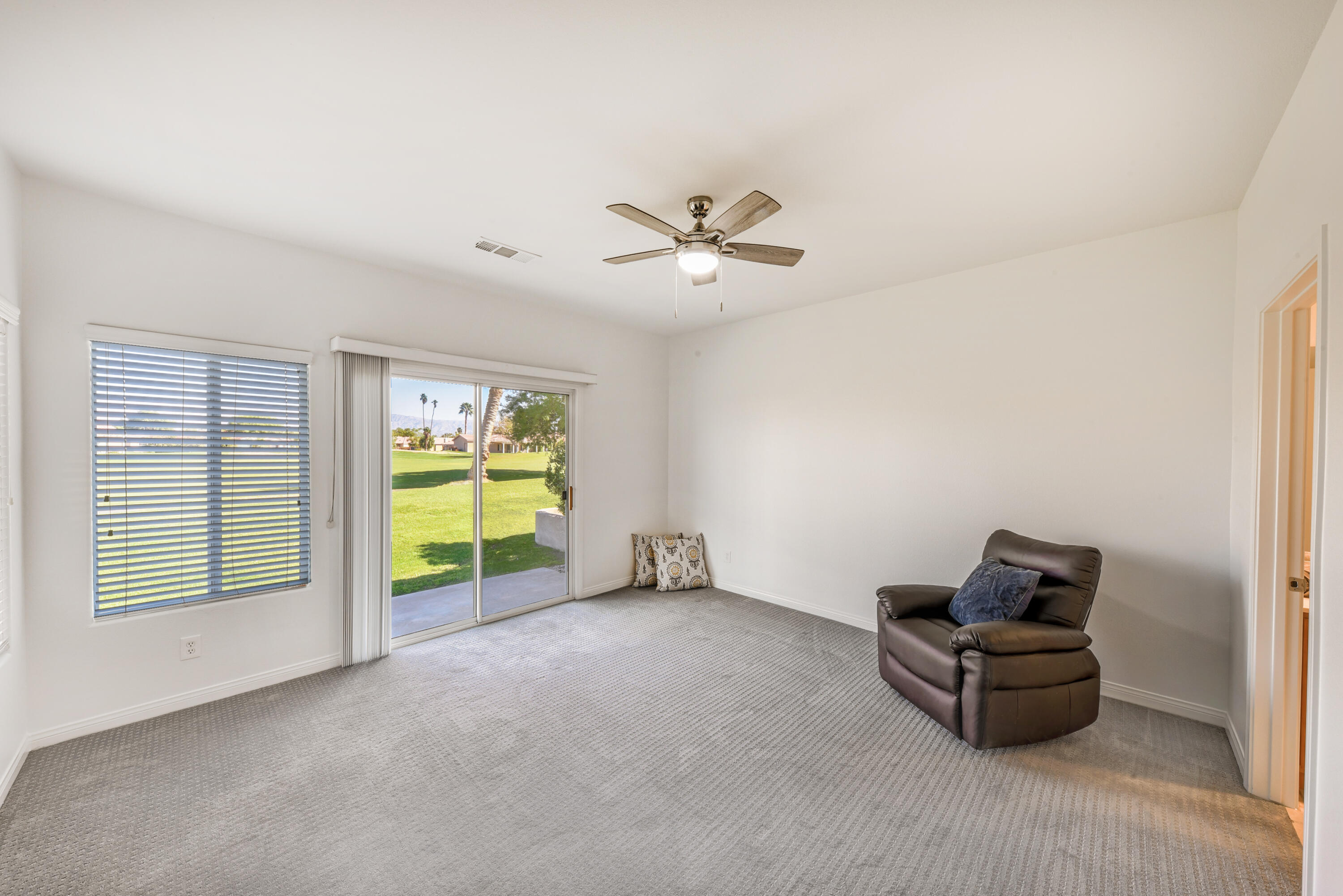 82346 Lancaster Way, Unit 125 Indio, CA 92201 - Photo 17 of 34 a living room with furniture and a chandelier
