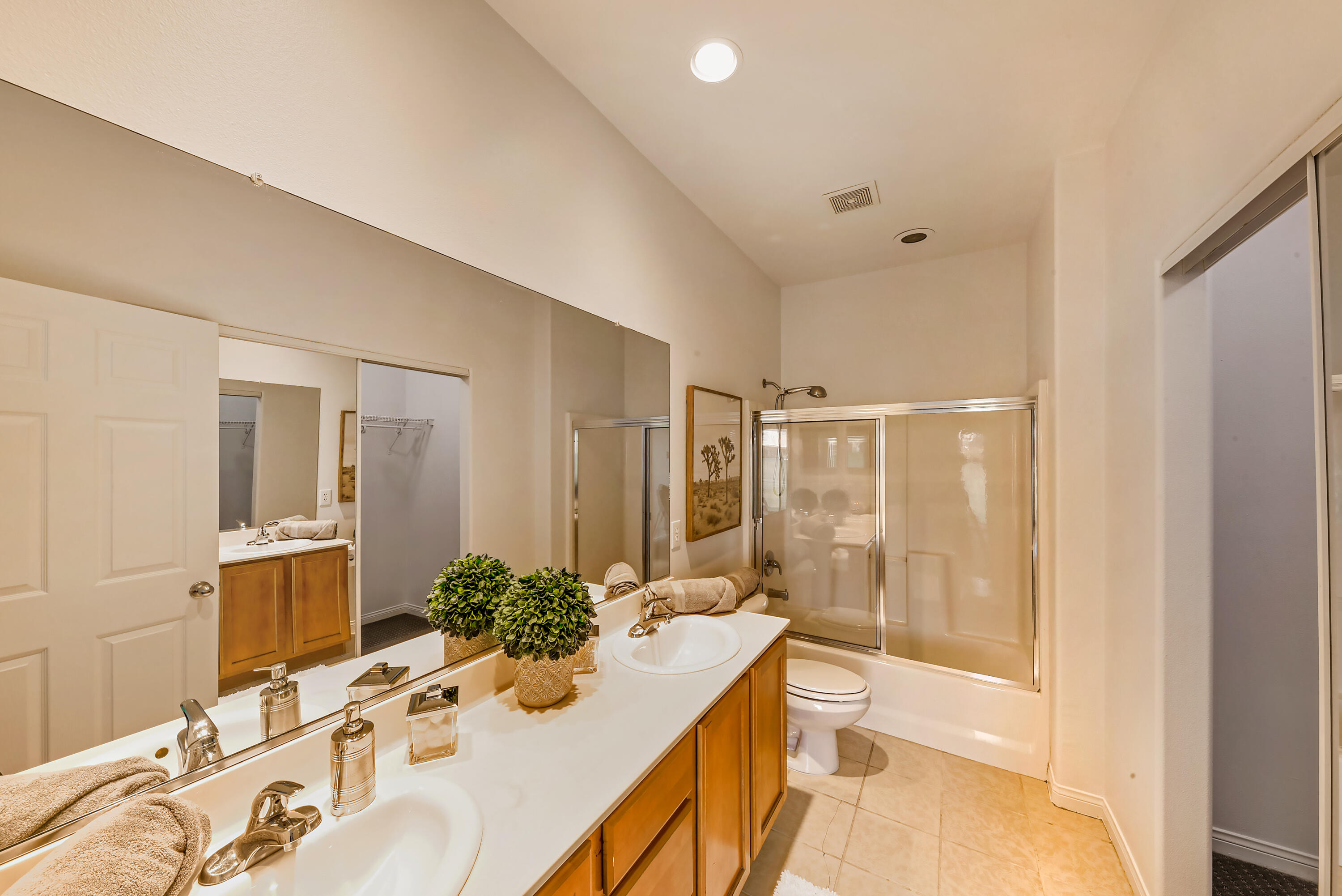 82346 Lancaster Way, Unit 125 Indio, CA 92201 - Photo 19 of 34 a bathroom with a granite countertop sink a toilet and shower