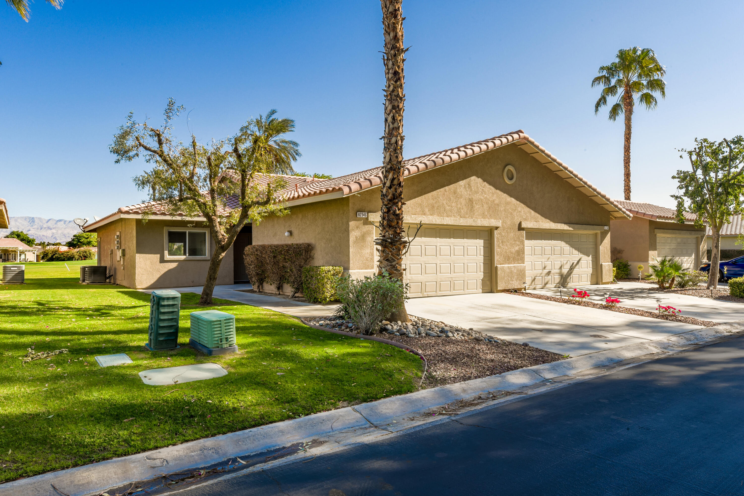 82346 Lancaster Way, Unit 125 Indio, CA 92201 - Photo 2 of 34 a front view of a house with garden