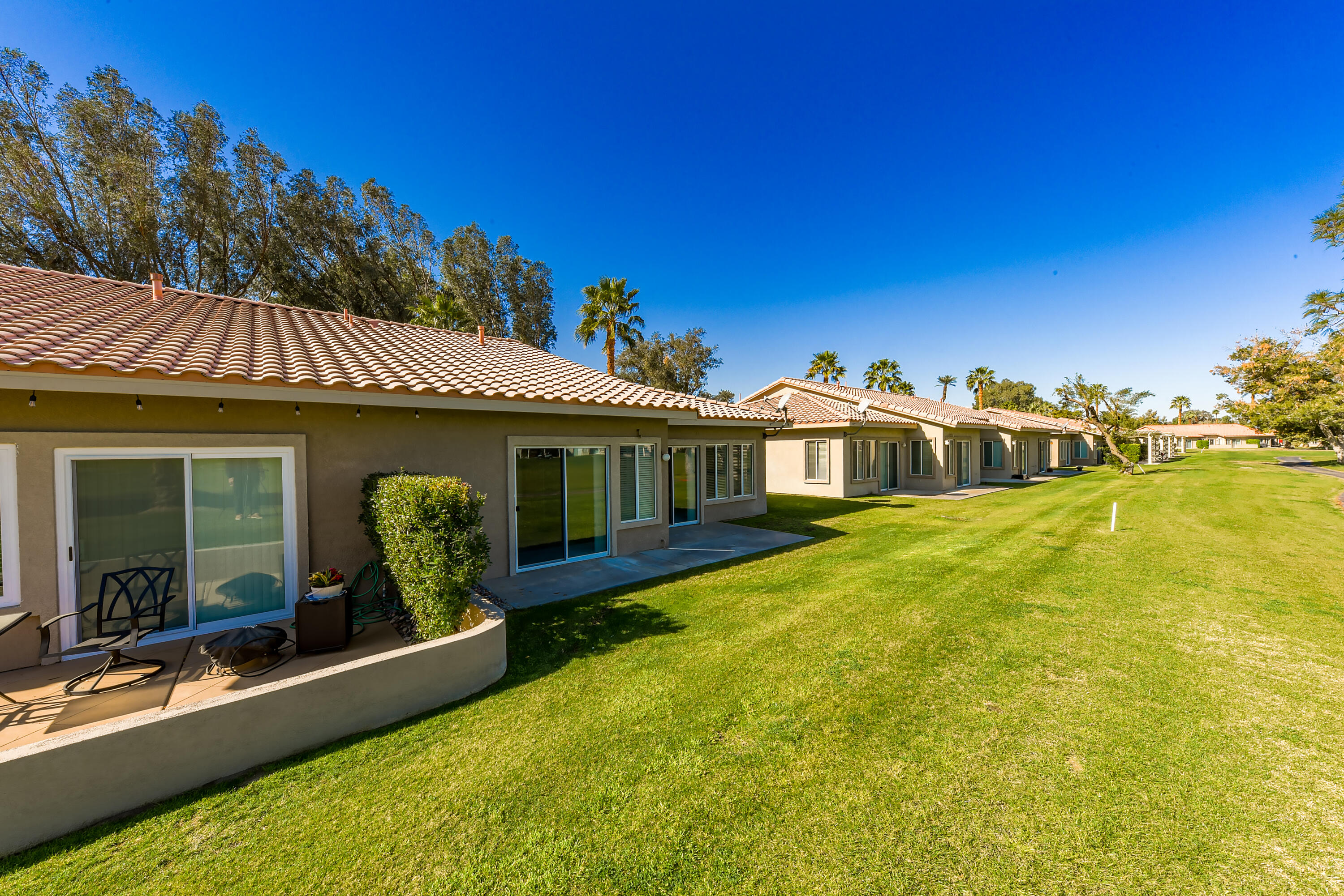 82346 Lancaster Way, Unit 125 Indio, CA 92201 - Photo 22 of 34 a front view of a house with garden