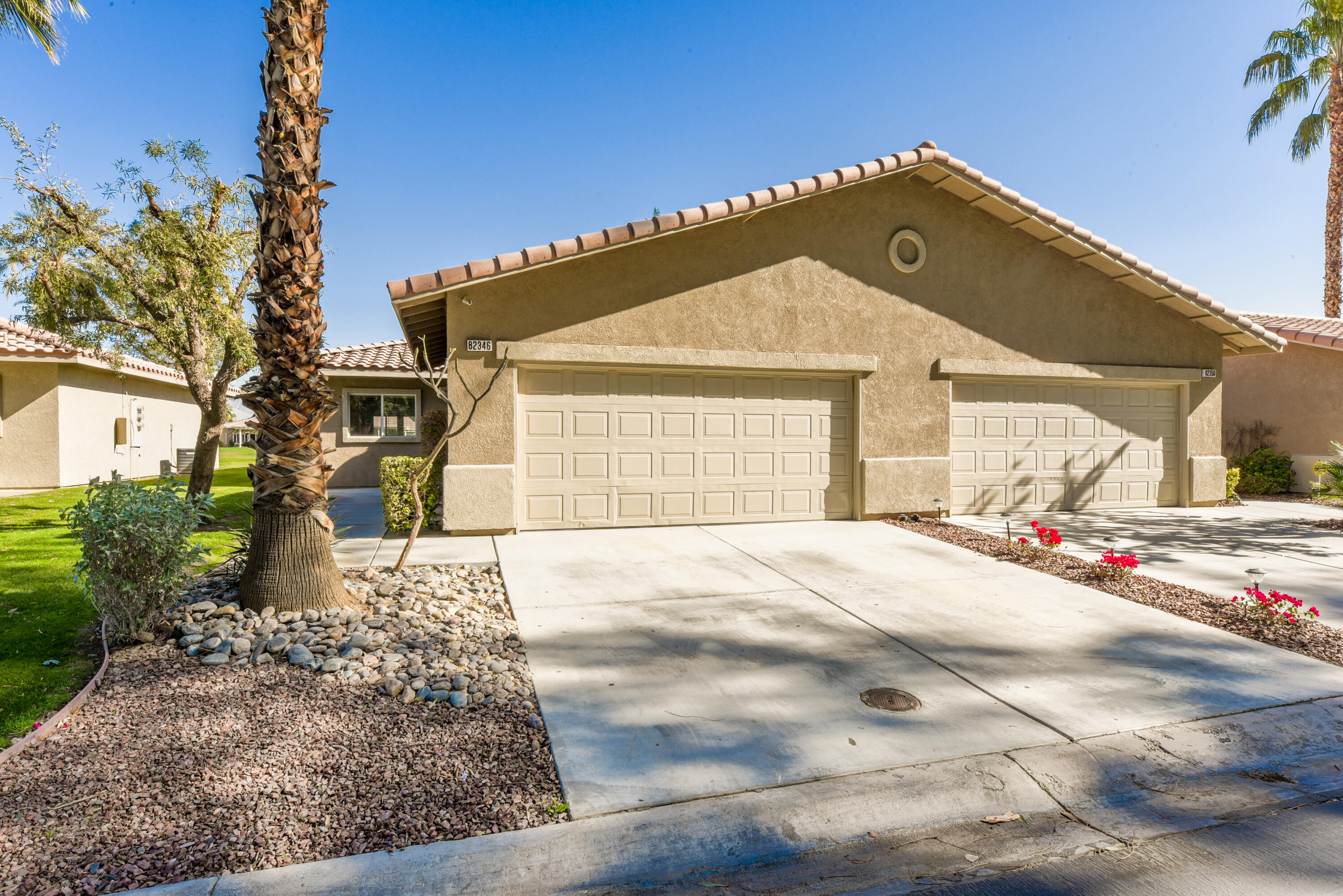 82346 Lancaster Way, Unit 125 Indio, CA 92201 - Photo 3 of 34 a front view of a house with a yard