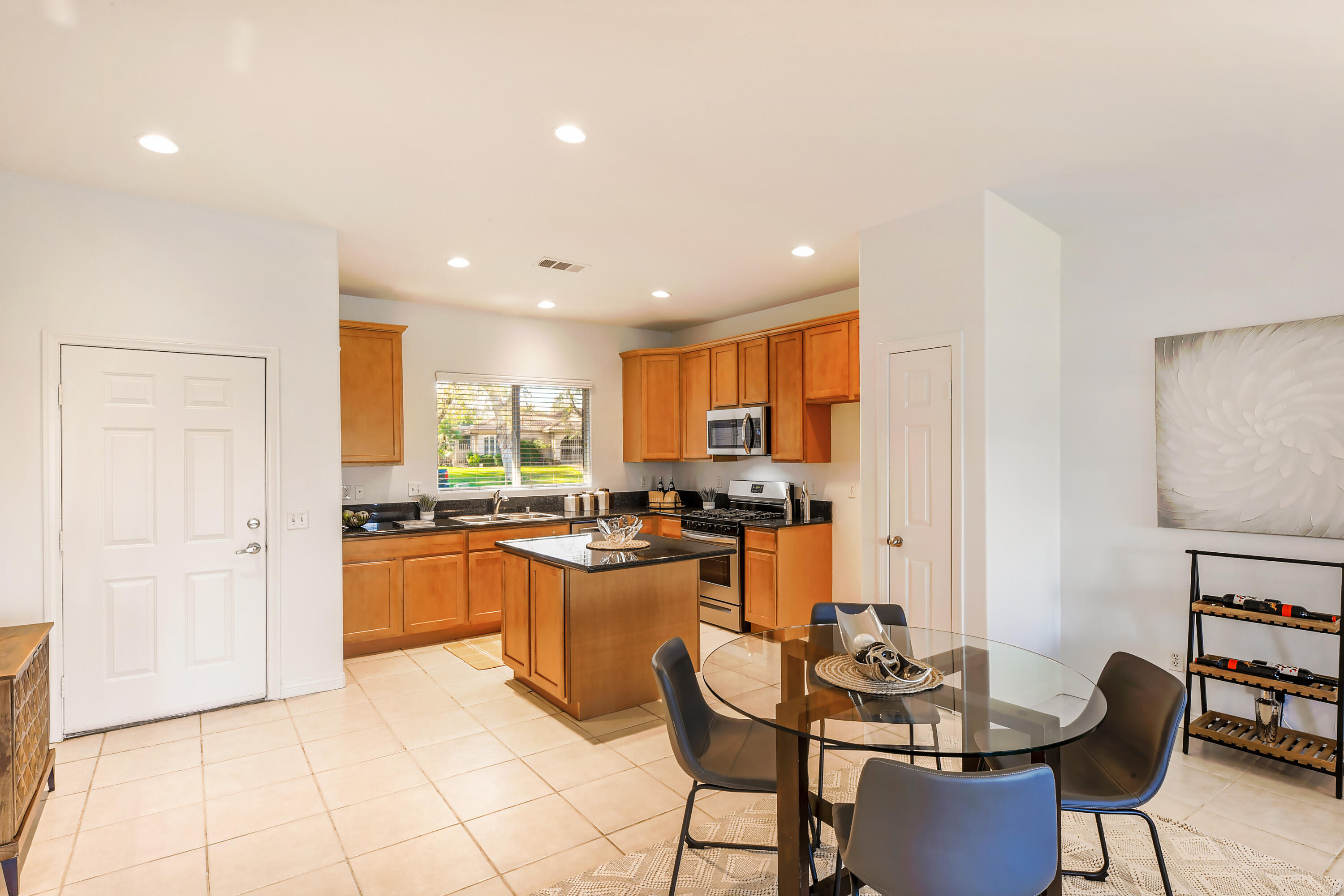 82346 Lancaster Way, Unit 125 Indio, CA 92201 - Photo 10 of 34 a kitchen with stainless steel appliances kitchen island granite countertop a sink and cabinets