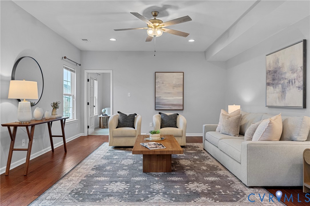 8316 Forge Road Henrico, VA 23228 - Photo 11 of 43 a living room with furniture a rug and a chandelier