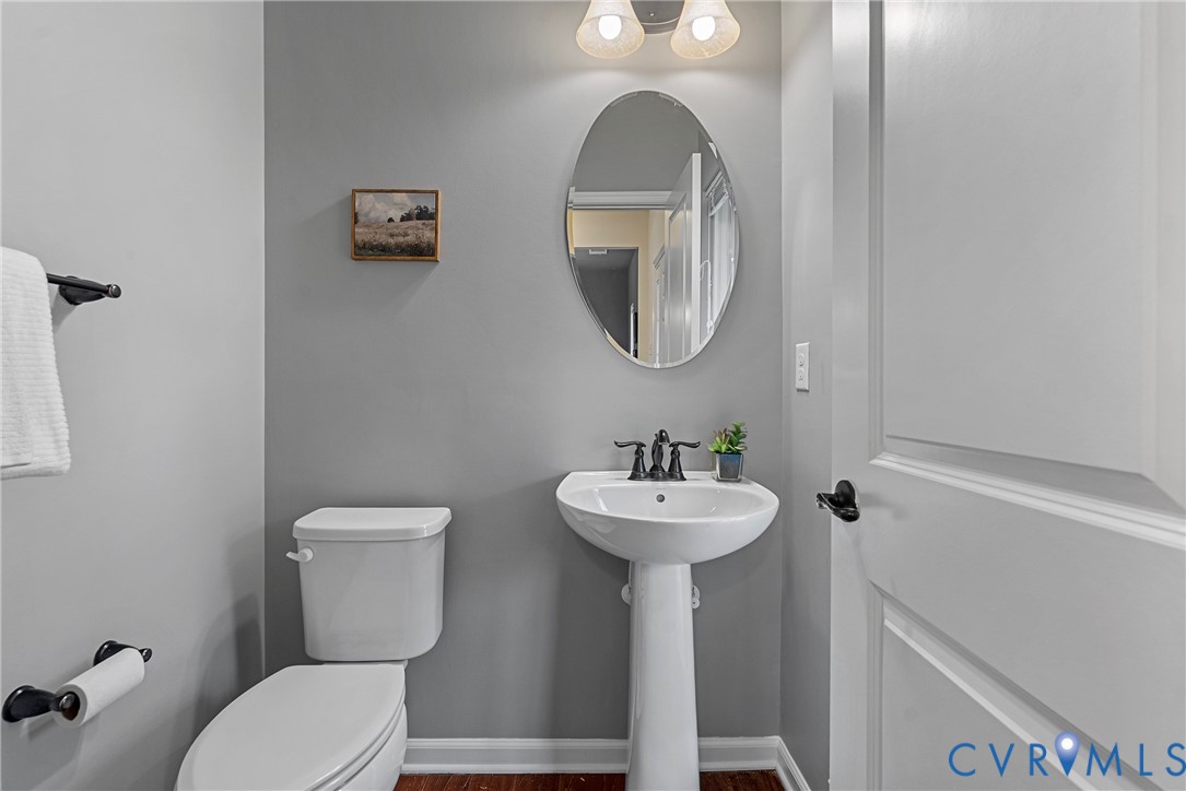 8316 Forge Road Henrico, VA 23228 - Photo 22 of 43 a bathroom with a toilet sink and mirror