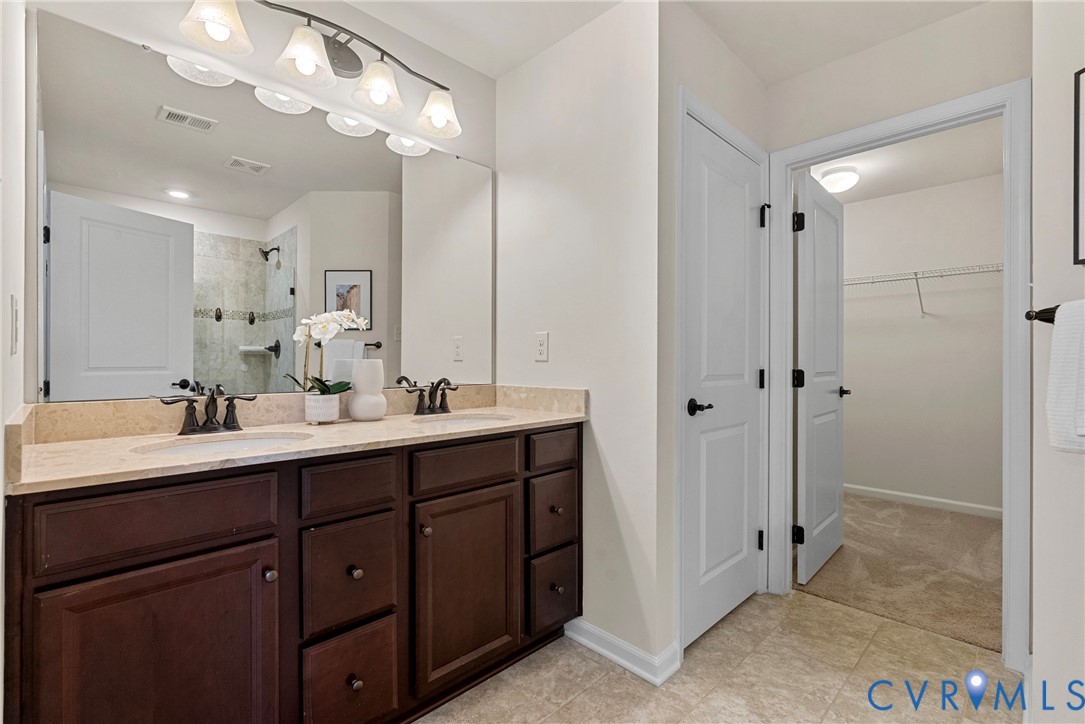 8316 Forge Road Henrico, VA 23228 - Photo 26 of 43 a bathroom with a sink vanity and a mirror