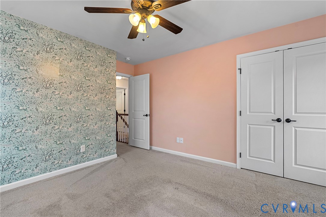 8316 Forge Road Henrico, VA 23228 - Photo 33 of 43 en empty room with a chandelier fan and closet area