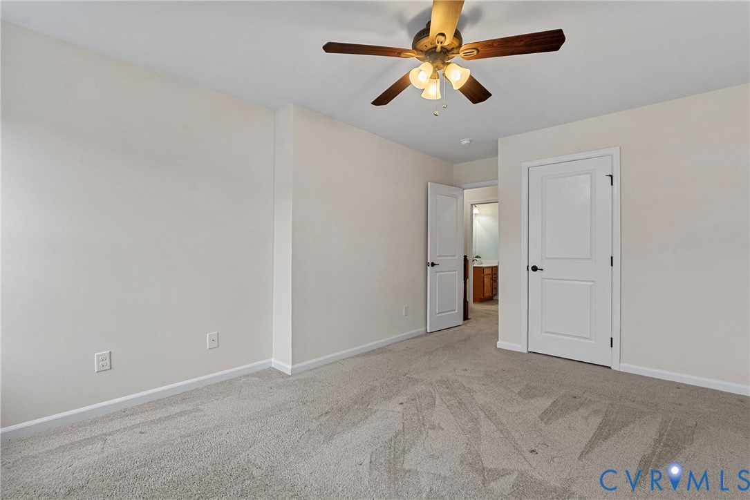 8316 Forge Road Henrico, VA 23228 - Photo 35 of 43 an empty room with closet and a chandelier fan