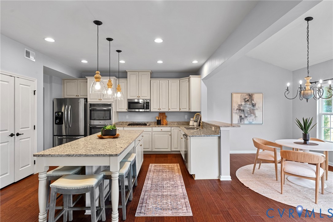 8316 Forge Road Henrico, VA 23228 - Photo 6 of 43 a large kitchen with a table and chairs