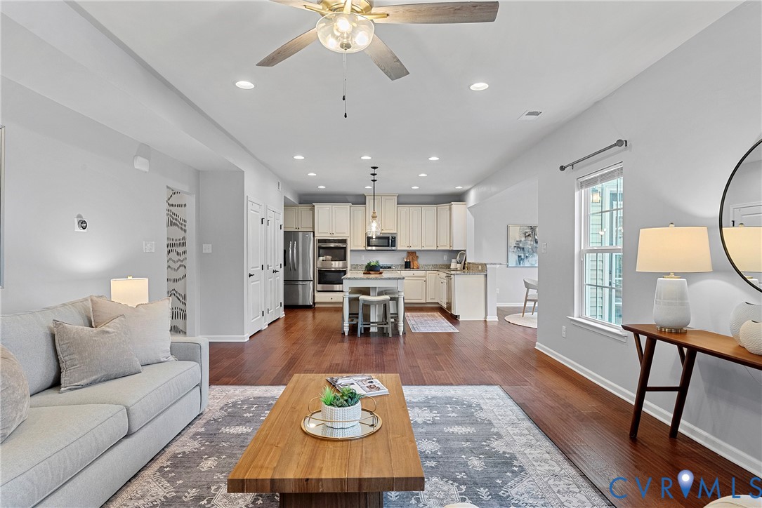 8316 Forge Road Henrico, VA 23228 - Photo 9 of 43 a living room with furniture and a dining table with kitchen view