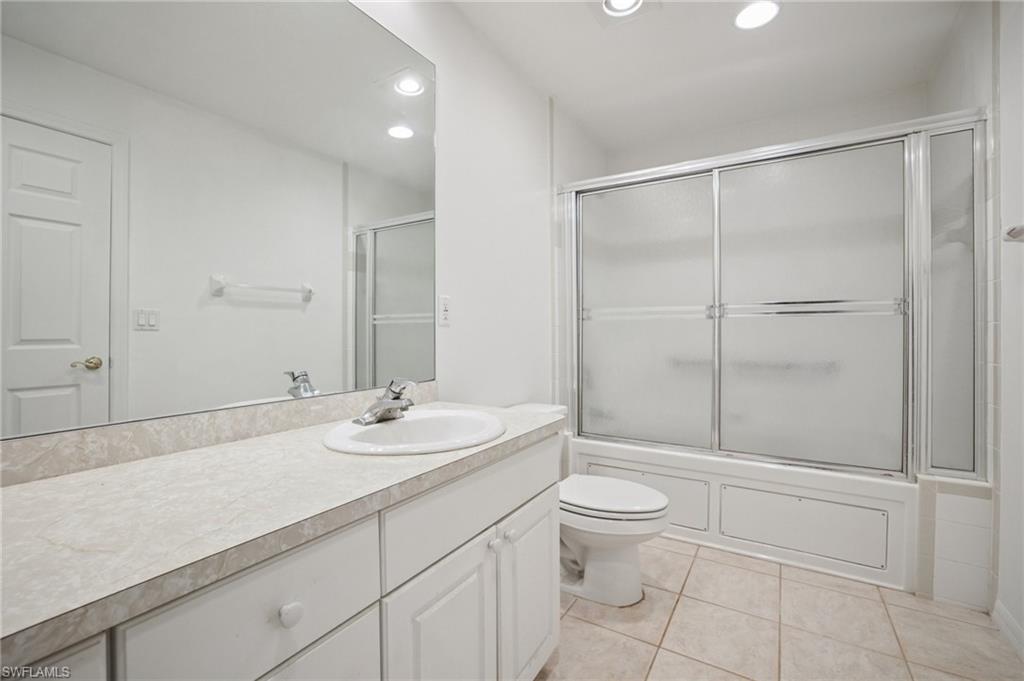 5348 Cypress Lane Naples, FL 34113 - Photo 26 of 28 a bathroom with a sink a toilet and shower