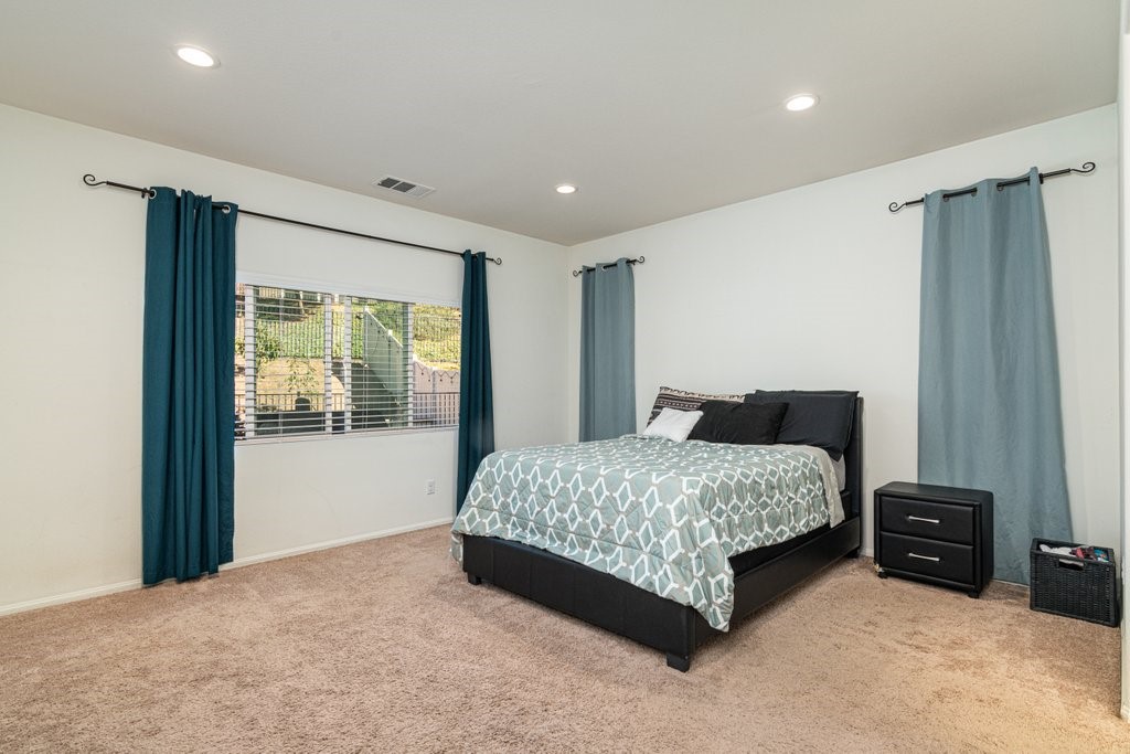 35851 Esperia Way Fallbrook, CA 92028 - Photo 11 of 28 a spacious bedroom with a bed and window