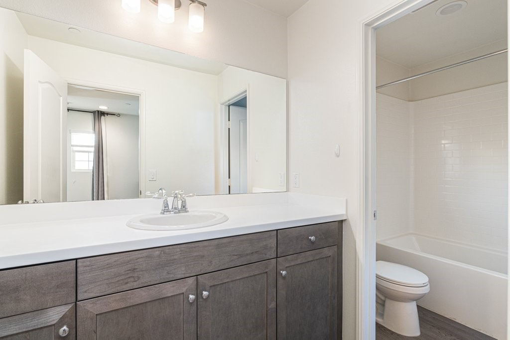 35851 Esperia Way Fallbrook, CA 92028 - Photo 18 of 28 a bathroom with a sink a toilet and a large mirror
