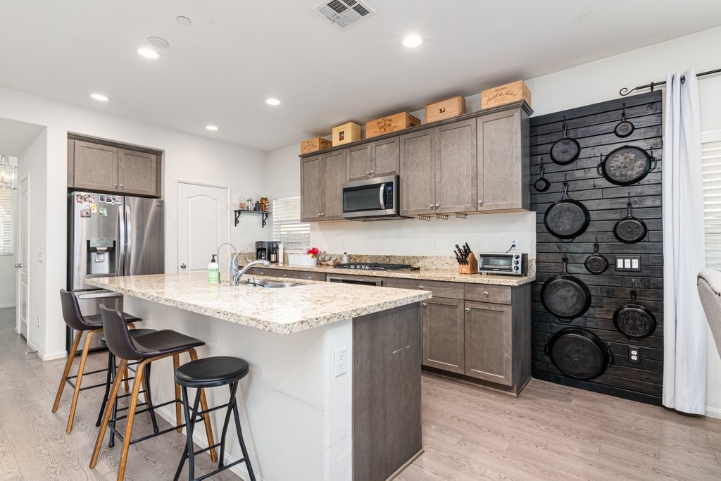 35851 Esperia Way Fallbrook, CA 92028 - Photo 6 of 28 a kitchen with stainless steel appliances granite countertop a sink and cabinets