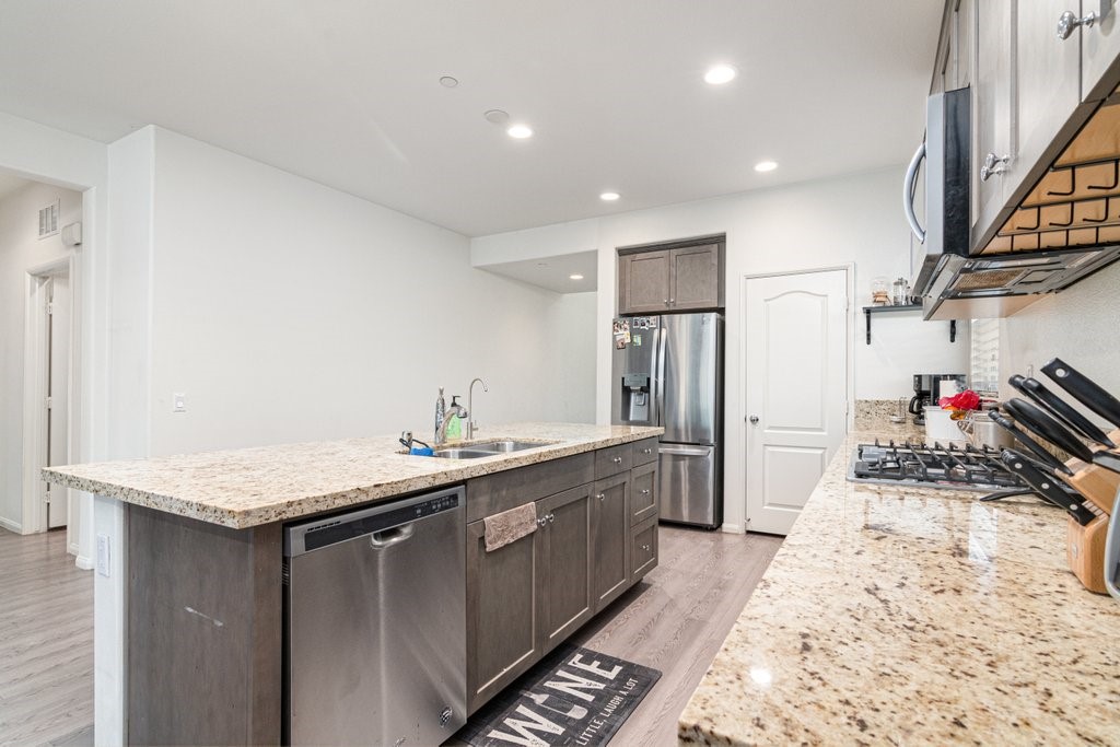 35851 Esperia Way Fallbrook, CA 92028 - Photo 7 of 28 a kitchen with stainless steel appliances granite countertop a sink stove and refrigerator
