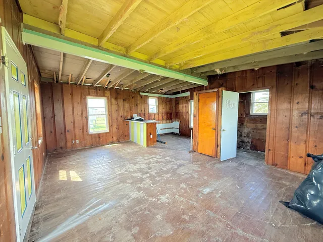 a view of empty room with wooden walls