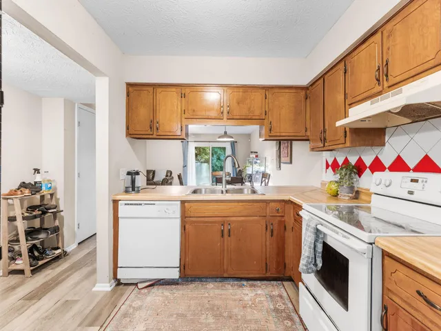 a kitchen with a sink a stove and a refrigerator
