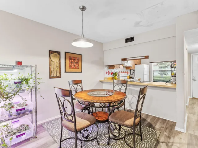 a view of a dining room with furniture wooden floor and a chandelier